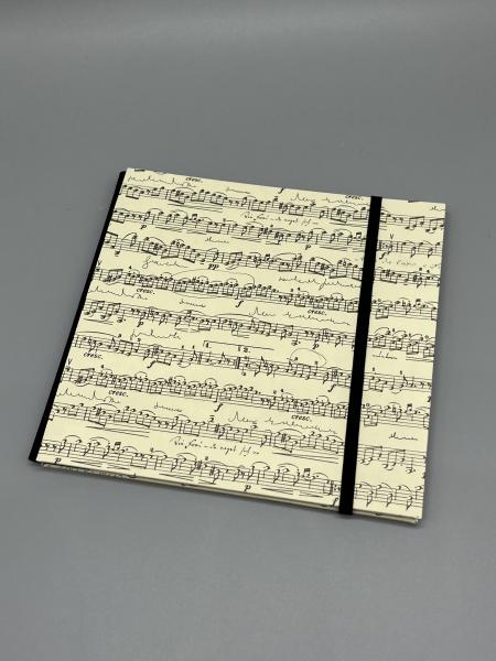 Buch Gummiband Fotos Seiten Faltung Faltbuch schwarz Musiknoten